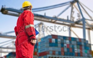 stock-photo-conceptual-image-of-international-logistics-featuring-a-docker-looking-at-the-unloading-of-a-139644776
