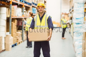 stock-photo-warehouse-worker-smiling-at-camera-carrying-a-box-in-a-large-warehouse-253977835
